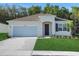 Charming single-story home with well-manicured lawn, attached garage, and inviting front entrance at 2980 Supermarine Rd, Tavares, FL 32778