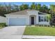 Charming single-story home with well-manicured lawn, attached garage, and inviting front entrance at 2980 Supermarine Rd, Tavares, FL 32778