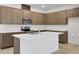 Beautiful kitchen with stainless steel appliances, plenty of cabinets, and a large island with seating space at 2980 Supermarine Rd, Tavares, FL 32778