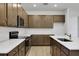 Well-equipped kitchen with ample cabinet space, stainless steel appliances, white backsplash, and center island sink at 2980 Supermarine Rd, Tavares, FL 32778