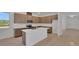 Bright kitchen with stainless steel appliances, white countertops, tile backsplash, and an island with a sink at 2980 Supermarine Rd, Tavares, FL 32778