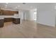 Open concept living room with hardwood floors leading to kitchen, creating a spacious and inviting atmosphere at 2980 Supermarine Rd, Tavares, FL 32778
