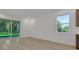 Bright living room with glass doors and a window, offering natural light and views at 2980 Supermarine Rd, Tavares, FL 32778