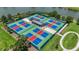 Aerial view of new pickleball courts with shade structures, surrounded by lush landscaping and scenic views of the lake at 3048 New Haven Pl, Mount Dora, FL 32757