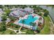 Aerial view of community clubhouse and large pool with surrounding amenities, offering residents recreational opportunities at 3048 New Haven Pl, Mount Dora, FL 32757