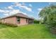 The house's backyard has a well-maintained lawn, featuring a screened-in porch and views of lush greenery at 3048 New Haven Pl, Mount Dora, FL 32757