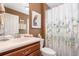 Bathroom featuring a single sink vanity, a floral shower curtain, and decorative artwork at 3048 New Haven Pl, Mount Dora, FL 32757