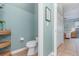 Powder room featuring a toilet and woven storage shelves adjacent to the bedroom at 3048 New Haven Pl, Mount Dora, FL 32757