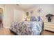 Bedroom showcasing floral bedding, a side table with a lamp, and a closet at 3048 New Haven Pl, Mount Dora, FL 32757