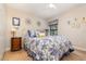 Comfortable bedroom with floral bedding and a side table with a lamp at 3048 New Haven Pl, Mount Dora, FL 32757