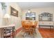 Cozy dining area with hardwood floors, wooden furniture, and a view into the adjacent kitchen at 3048 New Haven Pl, Mount Dora, FL 32757