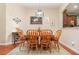 Traditional dining room with wood table set and a decorative chandelier overhead at 3048 New Haven Pl, Mount Dora, FL 32757