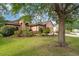 Charming home with lush landscaping, mature trees, and a well-manicured lawn enhancing curb appeal at 3048 New Haven Pl, Mount Dora, FL 32757