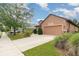 Exterior shot highlights a driveway leading to a two-car garage, complemented by manicured landscaping at 3048 New Haven Pl, Mount Dora, FL 32757