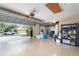 Spacious garage with epoxy flooring, overhead storage, and exterior view, offering ample space for vehicles and storage at 3048 New Haven Pl, Mount Dora, FL 32757