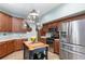 Bright kitchen featuring stainless steel appliances, an island, and ample storage space at 3048 New Haven Pl, Mount Dora, FL 32757
