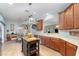Open kitchen features an island, stainless steel appliances, and ample counter space at 3048 New Haven Pl, Mount Dora, FL 32757