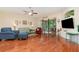 Bright living room with hardwood floors, ceiling fan and lanai access at 3048 New Haven Pl, Mount Dora, FL 32757