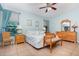 Cozy bedroom with comfortable furniture, ceiling fan and natural light at 3048 New Haven Pl, Mount Dora, FL 32757