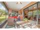 Cozy screened porch featuring a dining area and comfortable seating, perfect for enjoying meals and relaxation outdoors at 3048 New Haven Pl, Mount Dora, FL 32757