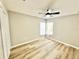 Cozy bedroom with new flooring, ceiling fan, and window at 3275 Oak Brook Ln, Eustis, FL 32736