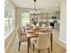 Dining room with modern chandelier, table set for six, and adjacent kitchen view at 3275 Oak Brook Ln, Eustis, FL 32736