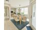 Open dining area showcasing large windows, a chandelier, and comfortable seating for six at 3275 Oak Brook Ln, Eustis, FL 32736