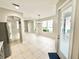 Open dining room with tile flooring, neutral paint, modern chandelier, and large windows providing ample light at 3275 Oak Brook Ln, Eustis, FL 32736