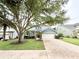 Charming home featuring a well-kept lawn and a two-car garage at 3275 Oak Brook Ln, Eustis, FL 32736
