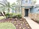 Charming home featuring stone accents, a well-manicured garden, and a welcoming front entrance at 3275 Oak Brook Ln, Eustis, FL 32736