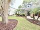 Beautiful front yard with lush landscaping, stone accents, and a welcoming entrance at 3275 Oak Brook Ln, Eustis, FL 32736