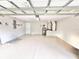 Spacious two car garage with epoxy flooring, insulated garage door, and ample space for vehicles and storage at 3275 Oak Brook Ln, Eustis, FL 32736