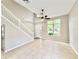 Bright living room features high ceilings, large windows, and neutral tile flooring throughout at 3275 Oak Brook Ln, Eustis, FL 32736