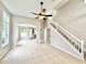 Open concept living room with easy access to kitchen and staircase to the upper level at 3275 Oak Brook Ln, Eustis, FL 32736