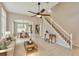 Open-concept living area with dining room, kitchen, staircase, and comfortable seating at 3275 Oak Brook Ln, Eustis, FL 32736