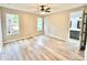Spacious main bedroom featuring wood flooring, neutral paint, large windows, and en-suite bathroom at 3275 Oak Brook Ln, Eustis, FL 32736