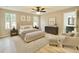 Spacious main bedroom with neutral decor, ceiling fan, and ensuite bathroom at 3275 Oak Brook Ln, Eustis, FL 32736