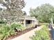 A charming outdoor kitchen and BBQ area perfect for gatherings, complemented by beautiful foliage at 3275 Oak Brook Ln, Eustis, FL 32736