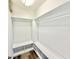 Well-organized walk-in closet with custom shelving, hanging rods, and wood flooring for optimal storage at 3275 Oak Brook Ln, Eustis, FL 32736