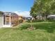 Spacious backyard featuring a screened-in patio and mature trees at 3551 Mulberry Grove Loop, Leesburg, FL 34748