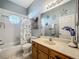 Well lit bathroom featuring decorative accents and a tub shower combo at 3551 Mulberry Grove Loop, Leesburg, FL 34748