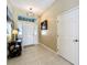 Bright foyer featuring tile flooring, transom window, and an elegant chandelier at 3551 Mulberry Grove Loop, Leesburg, FL 34748