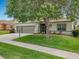 Inviting home with a well-maintained front yard, mature tree, and a convenient three-car garage at 3551 Mulberry Grove Loop, Leesburg, FL 34748