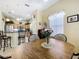 The kitchen has stainless steel appliances, wood cabinets, and seamless flow into the breakfast nook at 3551 Mulberry Grove Loop, Leesburg, FL 34748