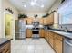 Well-equipped kitchen with stainless steel appliances, ample cabinetry, and modern countertops, perfect for culinary enthusiasts at 3551 Mulberry Grove Loop, Leesburg, FL 34748