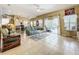 Open-concept living area with tile flooring and abundant natural light from the sliding glass doors at 3551 Mulberry Grove Loop, Leesburg, FL 34748