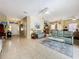 Expansive living room featuring tile floors, neutral wall color, and an open floor plan at 3551 Mulberry Grove Loop, Leesburg, FL 34748