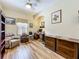Bright home office featuring built-in bookshelves and wood floors at 3551 Mulberry Grove Loop, Leesburg, FL 34748