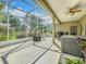 Covered patio overlooking the lawn, featuring a hot tub and outdoor furniture at 3551 Mulberry Grove Loop, Leesburg, FL 34748