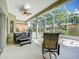 Enclosed patio featuring a hot tub and seating area at 3551 Mulberry Grove Loop, Leesburg, FL 34748